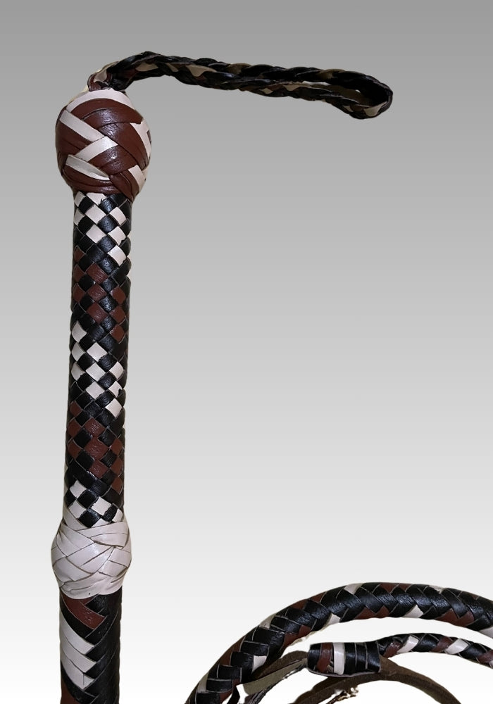 Close-up of the black and white bullwhip handle, wrist loop and braided pattern