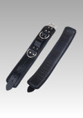 Black leather strap with metal buckles on a gray background