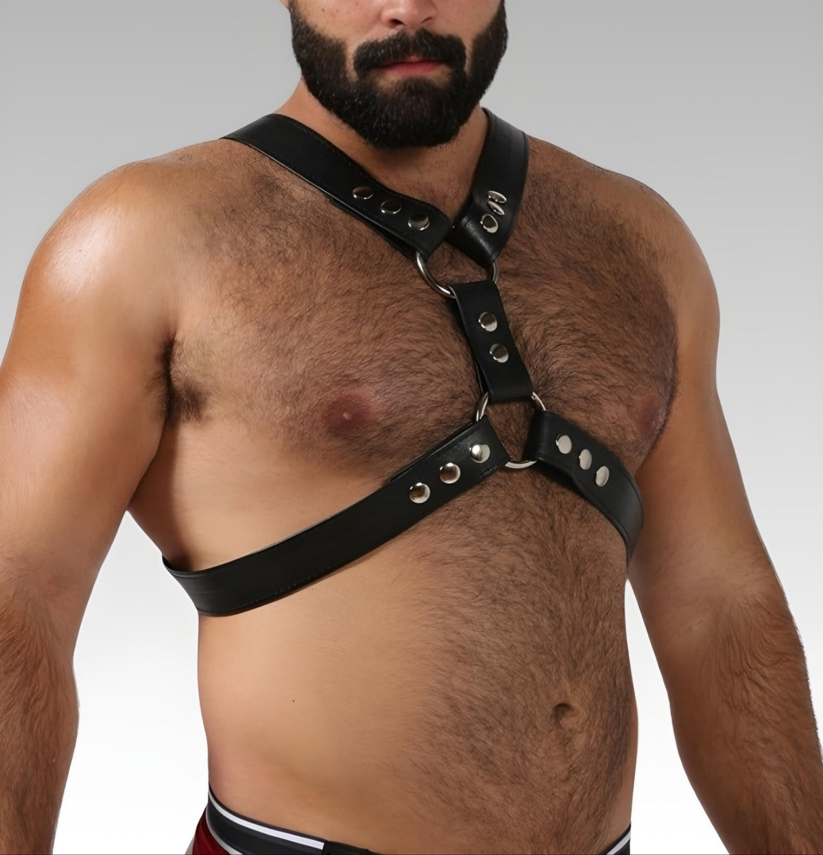 English Top black leather Y-front harness with silver snap closures, worn on the chest