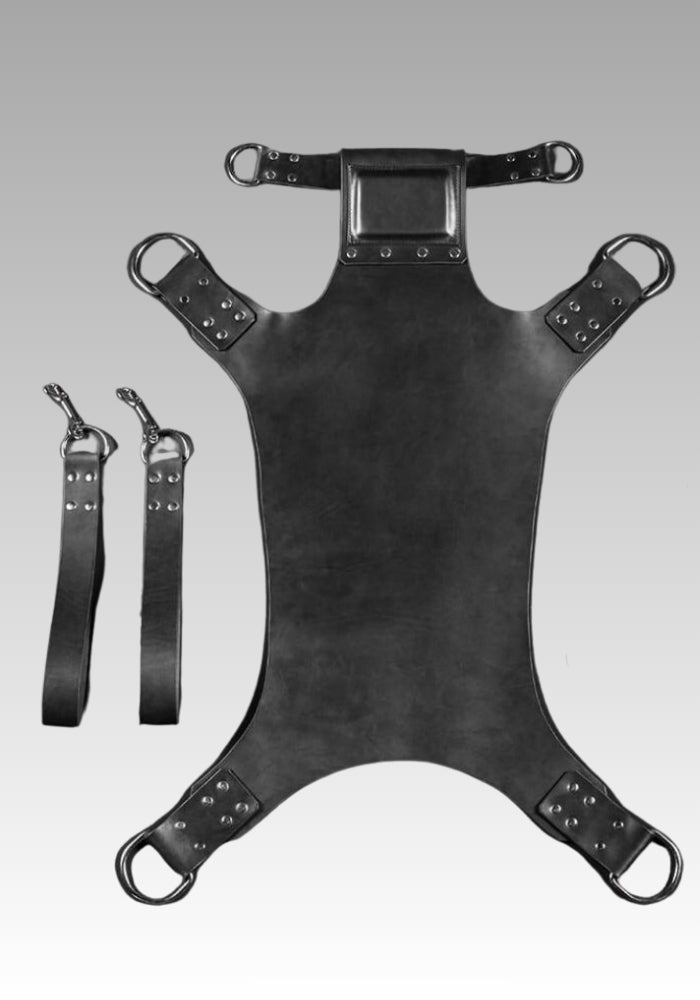 Five Point leather sling bed laid flat with pillow, attachment rings and separate stirrup straps