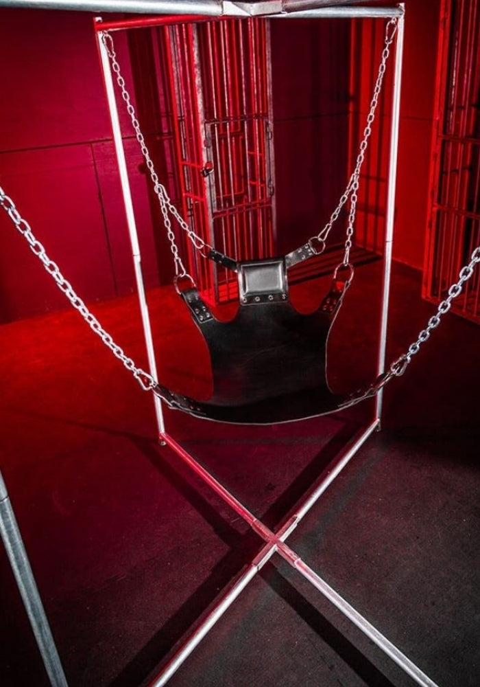 Five Point leather sling shown suspended from chains on a separate support frame