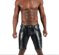 Man wearing black leather shorts on a white background