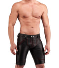 Man wearing black leather shorts with red stitching on a white background