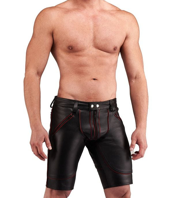 Man wearing black leather shorts with red stitching on a white background