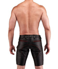 Man wearing black leather shorts with red stitching for sale