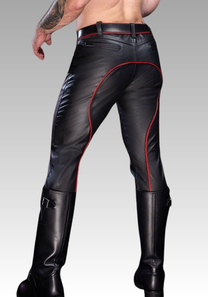 Black leather pants with red stitching worn by a person on a gray background