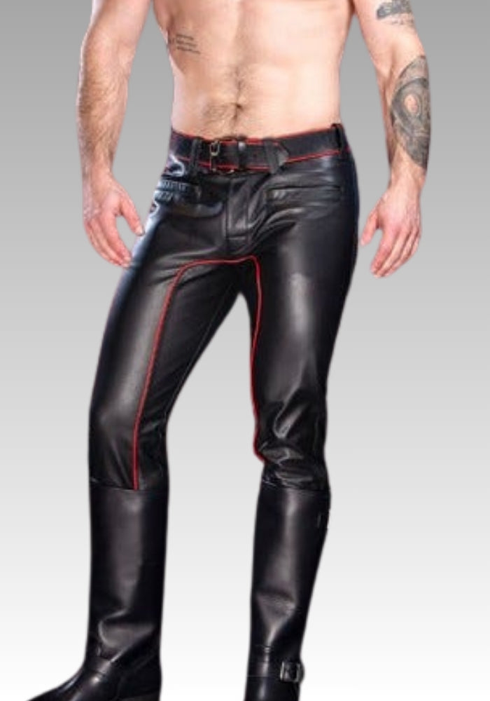 Man wearing black leather pants with red stitching on a gray background