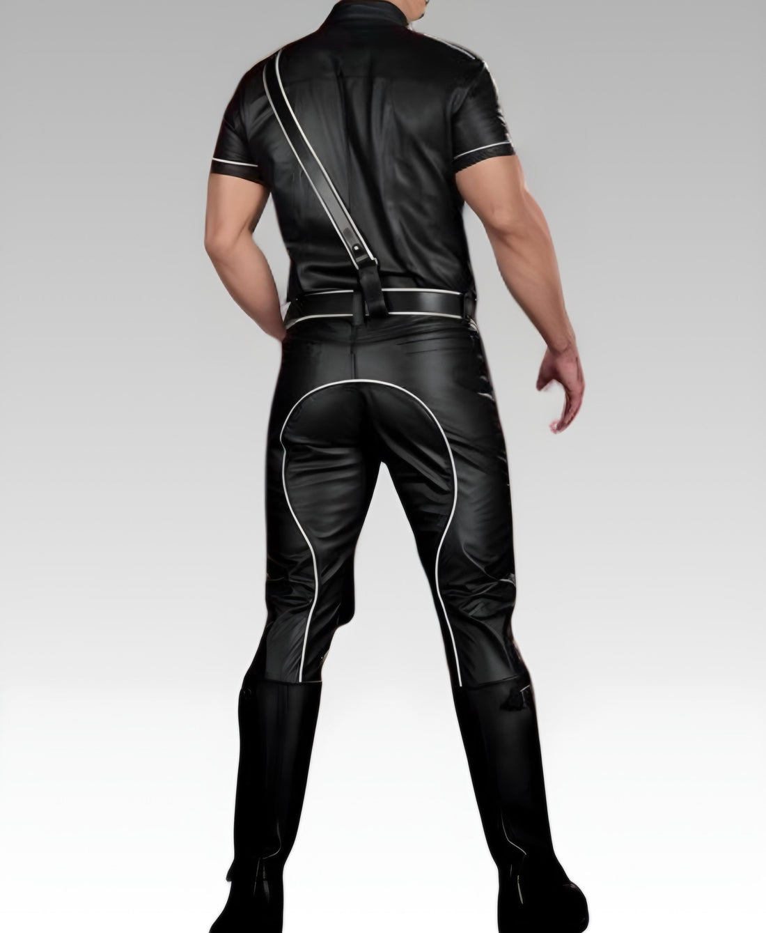 Black leather pants with white piping worn by a person on a gray background
