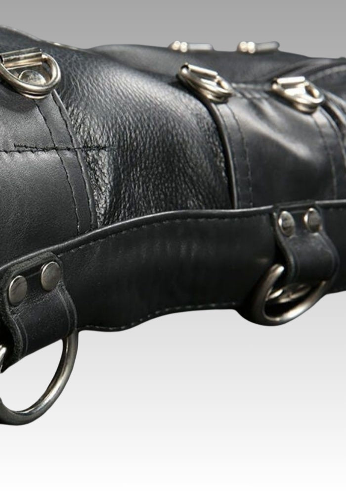 Close-up of black leather sleepsack straps, stitching and metal attachment rings