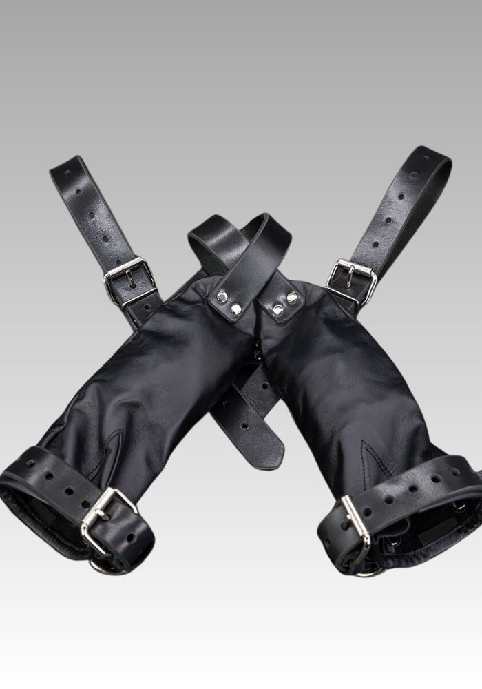 Pair of black leather mitts with buckle straps shown on a plain background
